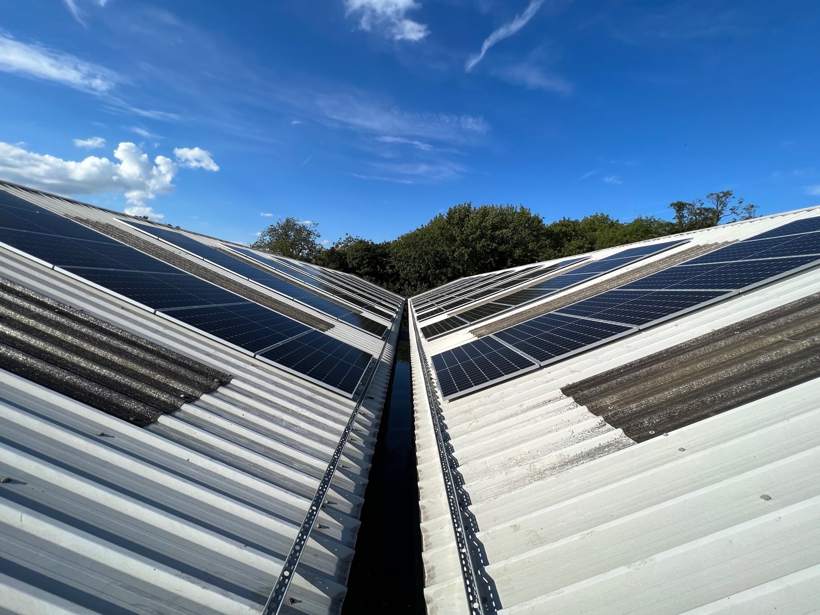 108 panels split east/west across the trapezoidal commercial roof — spreading generation across the whole working day.