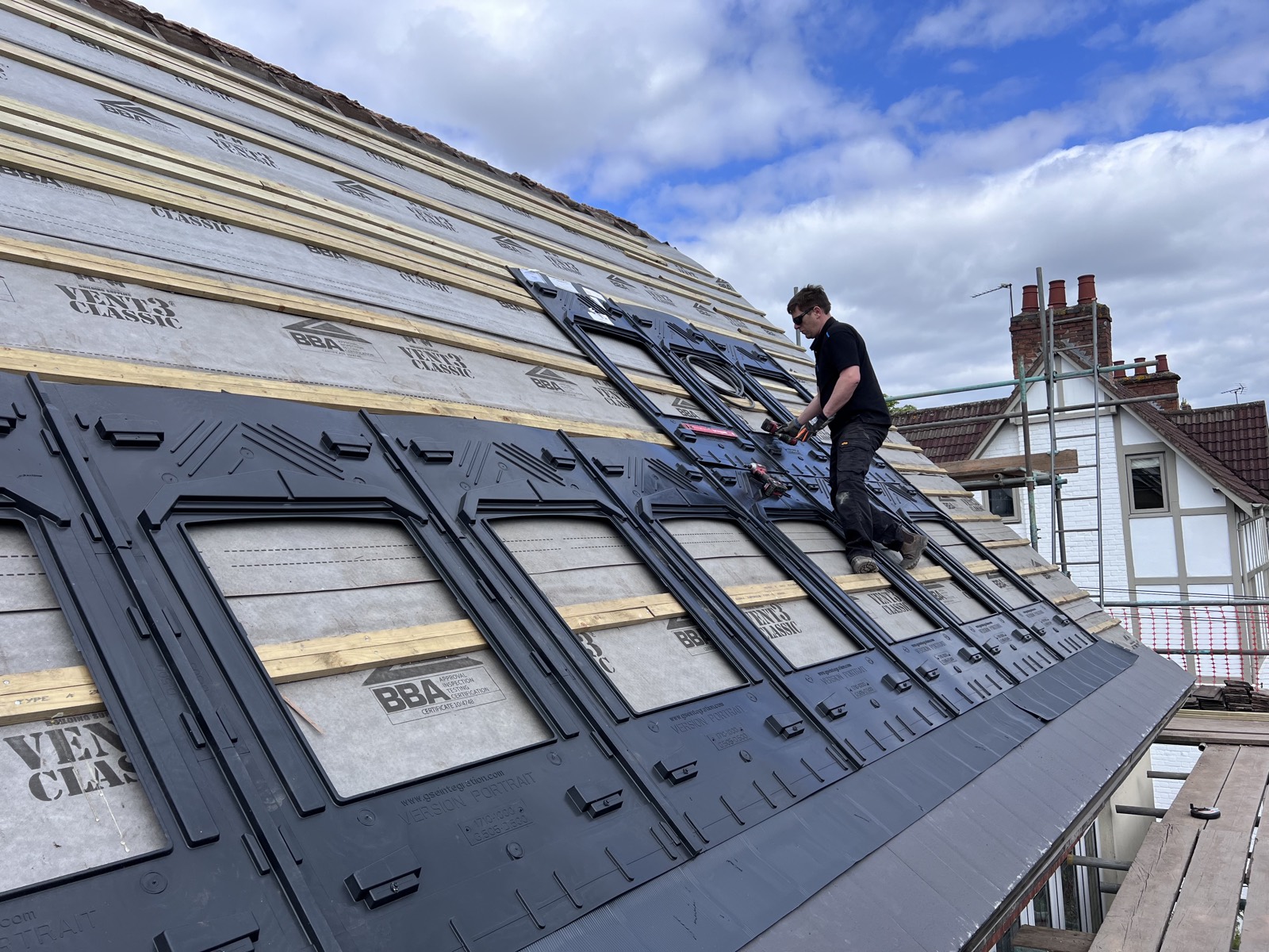 First, the GSE trays go in — fixed onto the roof structure where the tiles were, ready to receive the panels.